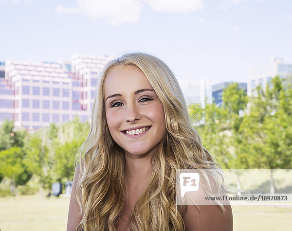 'Portrait of a beautiful young woman in a city park; Edmonton  Alberta  Canada'