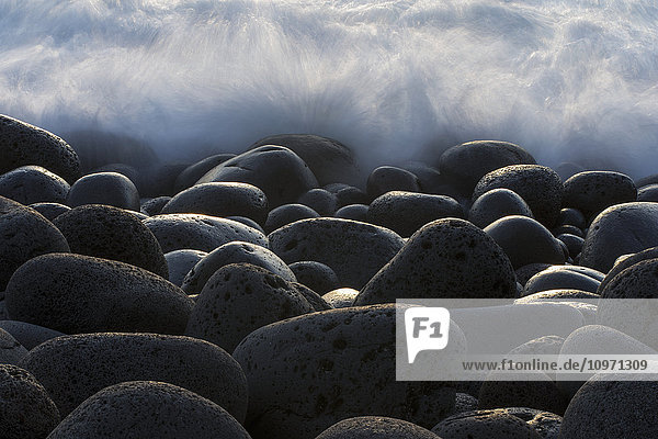 'Waves Crashing Over Round Rocks On The Southwestern Coast Of Iceland; Iceland'