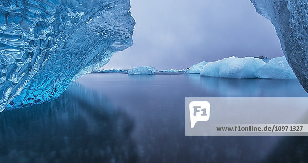 'Icebergs Reflected In Tranquil Water; Southern Iceland'