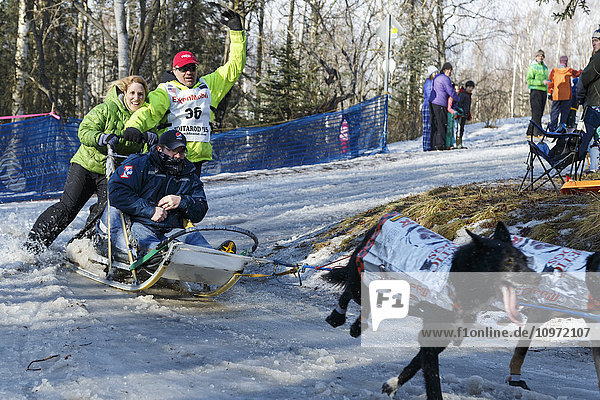 Ken Anderson rounds a bend at Goose Lake on the trail during the ceremonial start day of Iditarod 2015 in Anchorage  Alaska