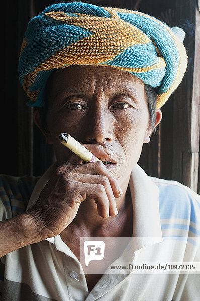 'A man smoking a cigar; Myanmar'