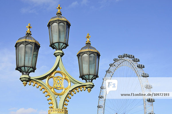 'Lamp post and London Eye from Westminster Bridge; London  England'