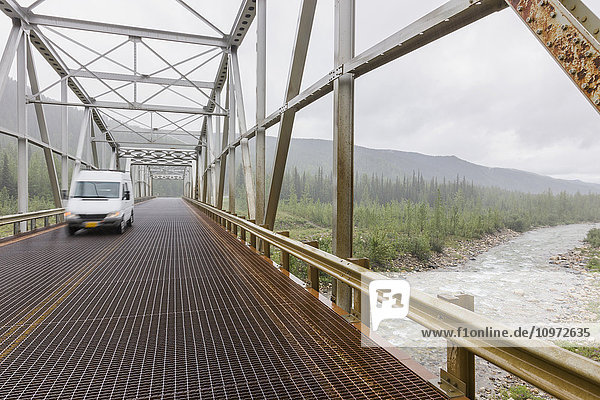 A van driving over the North Tetsa River Bridge  British Columbia  Canada  Summer