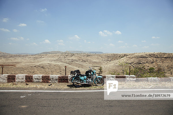 Mythisches Motorrad Royal Enfield mit Gepäck  geparkt am Straßenrand  Western Ghats; Karnataka  Indien'.