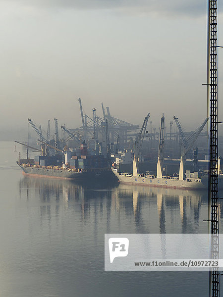 'Morning mist in the harbour with ships reflected in the water; Dar es Salaam  Tanzania'