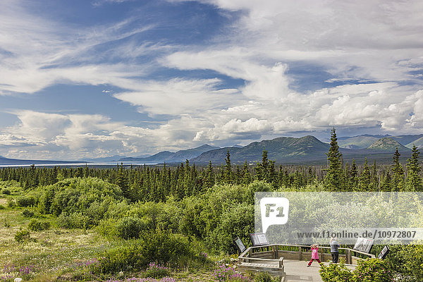Mother and daughter view scenery from a platform along the Alaska Highway south of Kluane Lake  Yukon Territory  Canada  summer