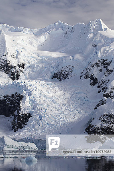 'Two kayakers in Paradise Harbor Antarctic Peninsula; Antarctica'