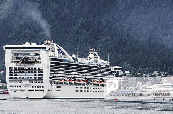 Cruise ship Star Princess maneuvers in Gastineau Channel to anchor at Juneau  Southeast Alaska  summer