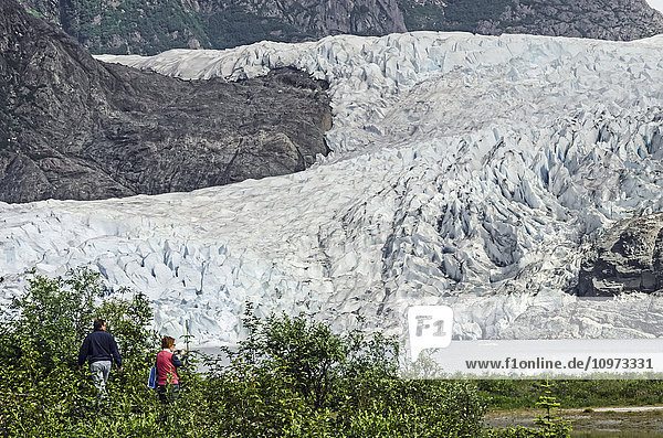 Tourists photographing Mendenhall Glacier in Tongass National Forest  Southeast Alaska  summer
