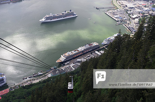 View of Celebrity cruises Ocean and Holland America's cruise ships in port with the Mt. Roberts tram in the foreground  Juneau  Southeast Alaska