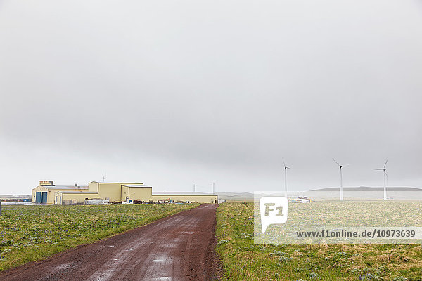 'Airport on St. Paul  a red dirt road in the foreground  St. Paul Island  Southwestern Alaska  USA  Summer'