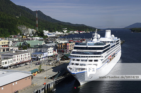 'Waterfront buildings and small cruise ship moored at the Ketchikan docks  Southeast Alaska  summer'