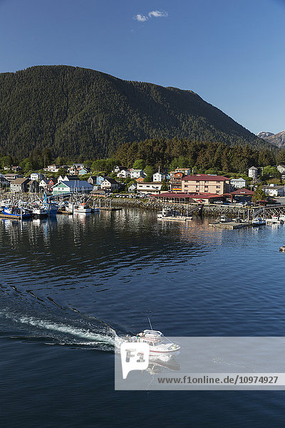 A small boat departs from Sitka Harbor on a clear day,  Southeast Alaska,  USA,  Summer