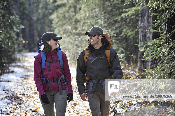 Backpacking couple walks the Albert Loop Trail in Chugach State Park near the Eagle River Nature Center in Southcentral Alaska