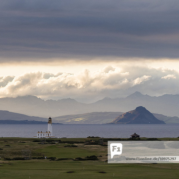 'Lighthouse and mountains along the coastline at Trump Turnberry Golf Resort; Turnberry  Scotland'