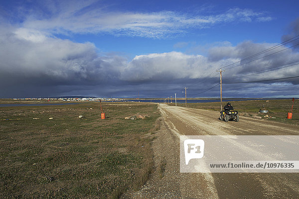 'ATV driving out of town; Cambridge Bay Nunavut  Canada'