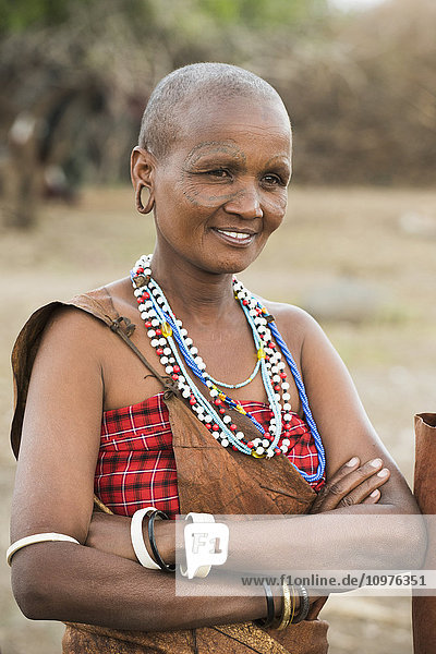 'Portrait of Datoga woman with tattooed face and wearing traditional clothing and jewelry  near Lake Eyasi; Tanzania'