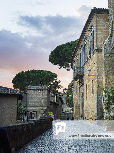 'Cobblestone street by a residential building at sunset; Orvieto  Umbria  Italy'