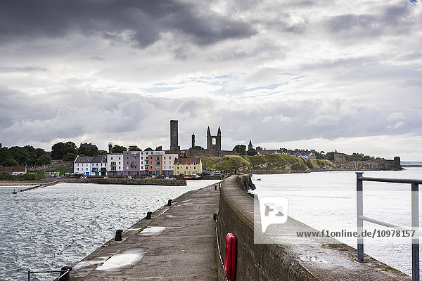 'A pier and colourful buildings along the harbour; St. Andrews  Fife  Scotland'