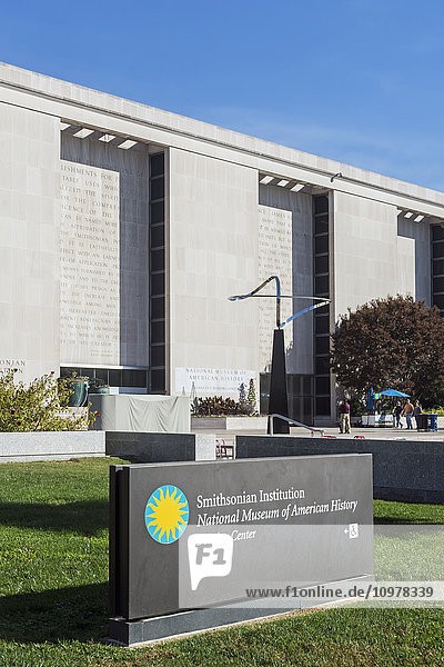 'Constitution Avenue entrance to the National Museum of American History Behring Centre  with the 24 foot sculpture called Infinity  dedicated at the National Mall entrance and designed by Jose de Rivera and created by Roy Gussow  building named after Kenneth Behring  a philanthropist who donated $80 to museum in 2000; Washington  District of Columbia  United States of America '