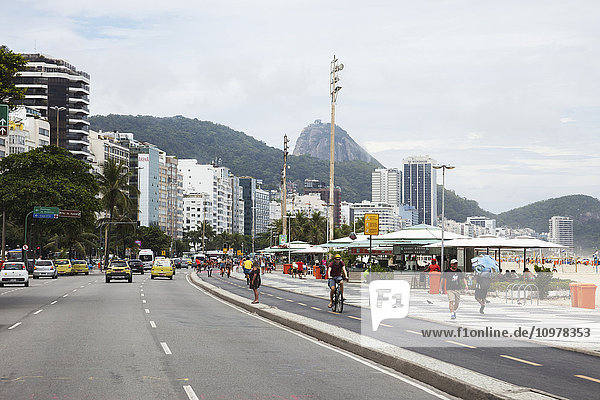 Copacabana Beach und Avenue Atlantica  mit dem Zuckerhut in der Ferne; Rio de Janeiro  Brasilien'.