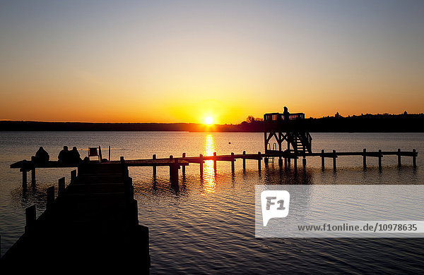 'Silhouette of a dock on a lake at sunset  Am Ammersee  near Herrsching; Germany'