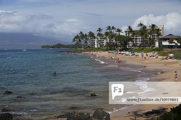 'Swimmers,  stand up paddle boarders,  sun bathers,  condo or hotel,  Kamaole I Beach Park; Kihei,  Maui,  Hawaii,  United States of America'