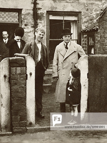 The Prince of Wales  later King Edward VIII visiting a miner's house and family in Durham in 1929. From The Story of 25 Eventful Years in Pictures published 1935