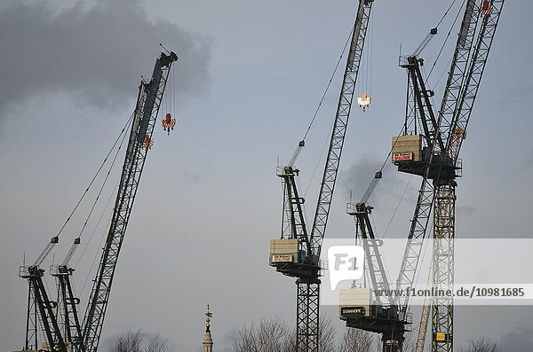 'Tower construction cranes on the north side of the river Thames seen from Blackfriars Bridge; London  England'