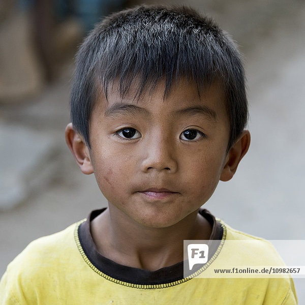'Portrait of a young boy with a dirty face; Paro  Bhutan'