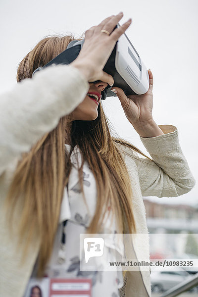 Frau schaut durch die VR-Brille im Freien