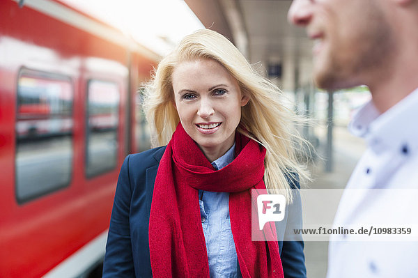 Smiling woman and man at station platform
