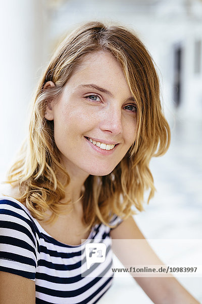 Portrait of smiling young woman wearing striped t-shirt