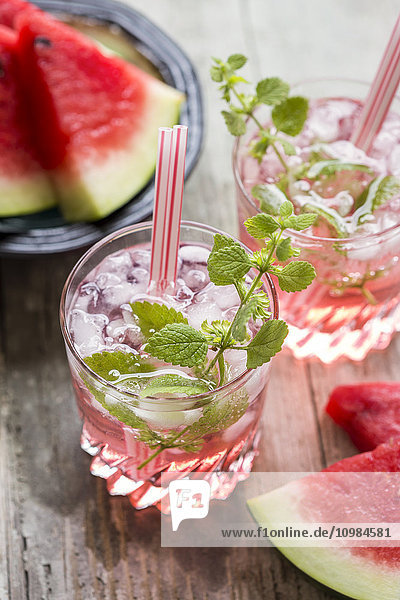 Fresh mineral water with watermelon  sirup and ice in glasses