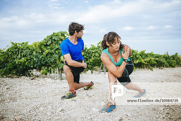 Couple doing sport in a vineyard