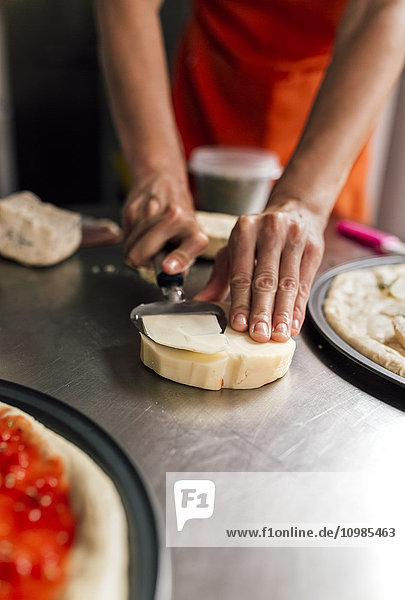 Woman's hand using cheese slicer