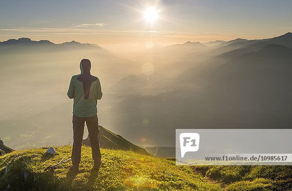 Austria  Tyrol  hiker looking at distance at sunrise