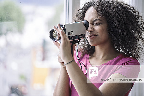 Young woman using old school camera