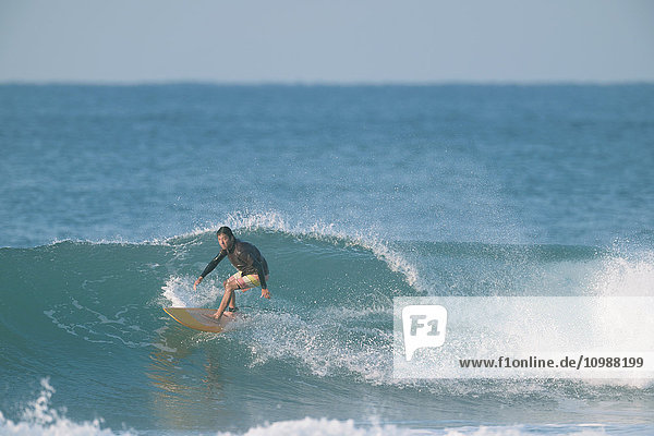 Japanese surfer riding wave