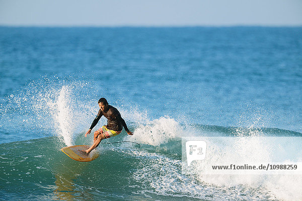 Japanese surfer riding wave