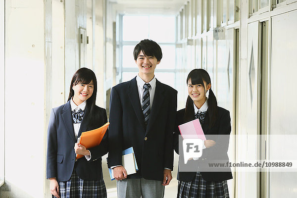 Japanese high-school students in school corridor
