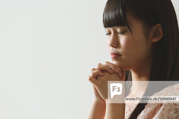 Japanese young woman praying