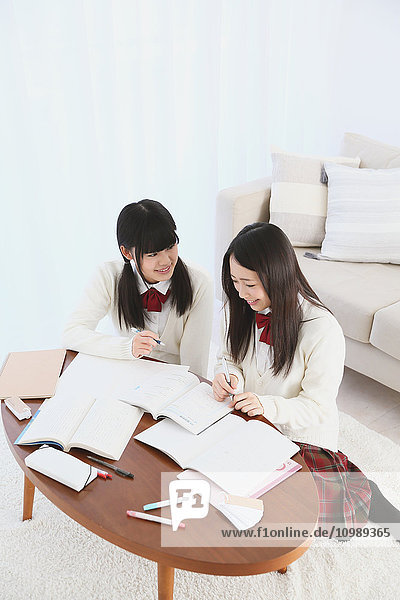 Japanese High-school students in uniform studying together