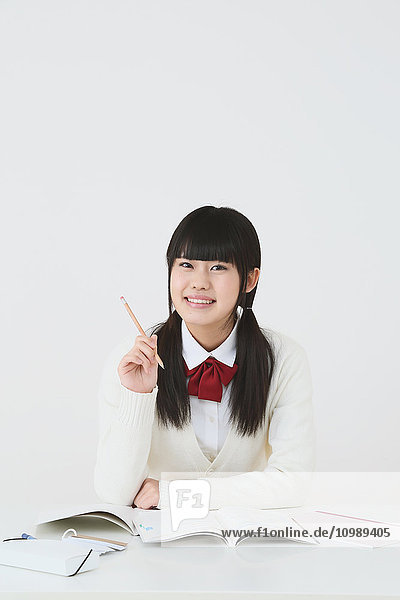 Japanese High-school student in uniform against white background