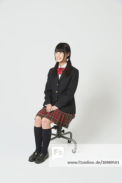 Japanese High-school student in uniform against white background