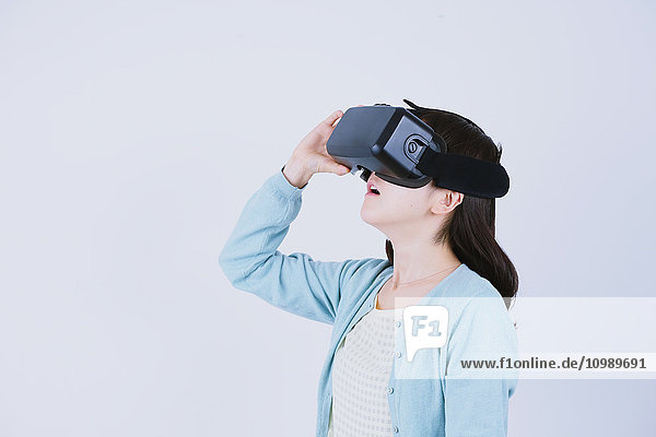 Japanese woman using virtual reality device