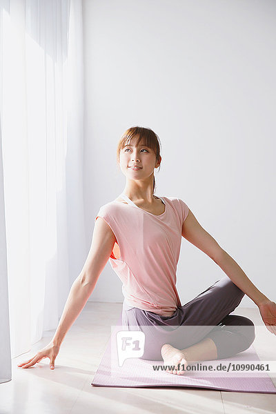 Young Japanese woman practicing yoga