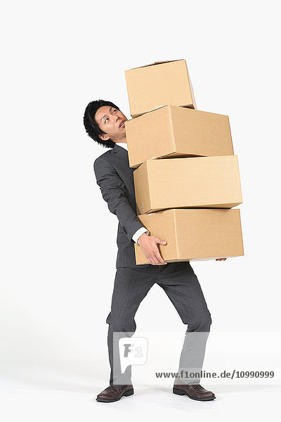 Young Japanese businessman carrying boxes