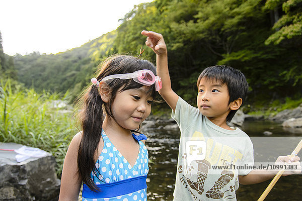 Japanese kids playing at the river