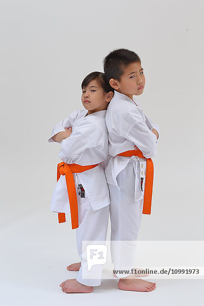 Japanese kids in karate uniform on white background